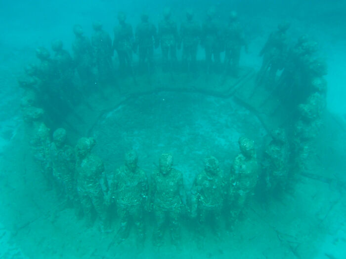 Underwater circle of human sculptures marking a strange ocean discovery.