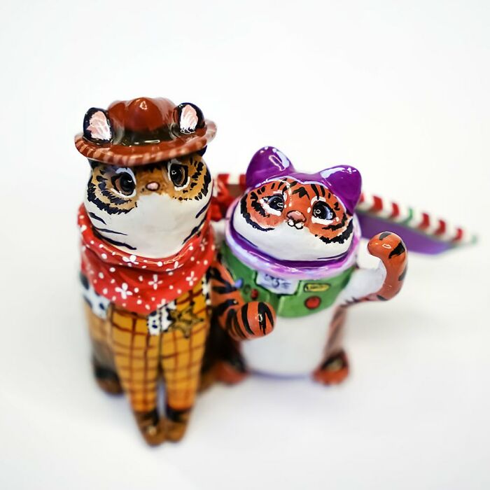 Pocket-sized animal figurines by Vallavica, featuring a cowboy cat and a space-themed cat, both looking adorable.