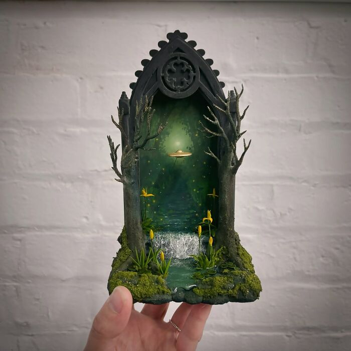 Alien-themed diorama with a UFO in a mystical forest setting, showcasing intricate details by Caroline Dewison.
