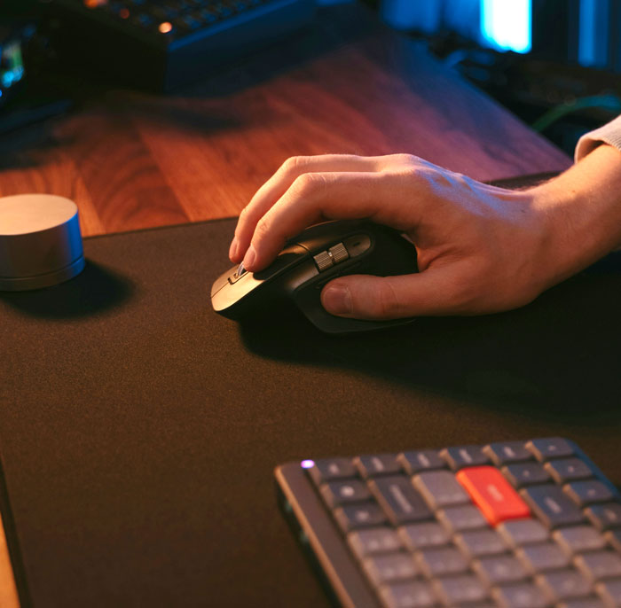 Hand using a computer mouse on a desk, representing internet hacks to make life easier online.