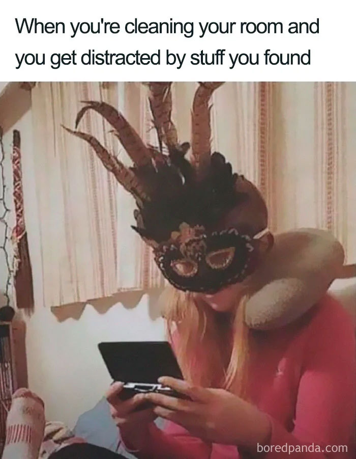 Person wearing a masquerade mask and holding a device, epitomizing random humor.