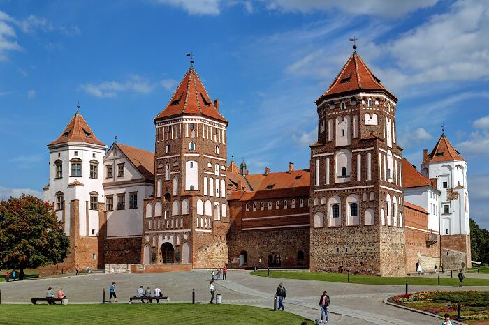 Historic castle with red brick towers and ornate architecture, showcasing a lesser-known architectural wonder.