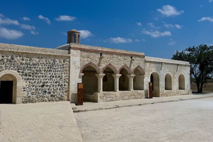 Historic architectural wonder featuring arches and stonework under a blue sky, not very well-known.