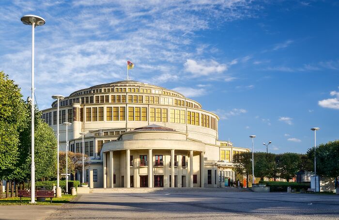 A lesser-known architectural wonder, a round building with a flag on top, under a clear blue sky.