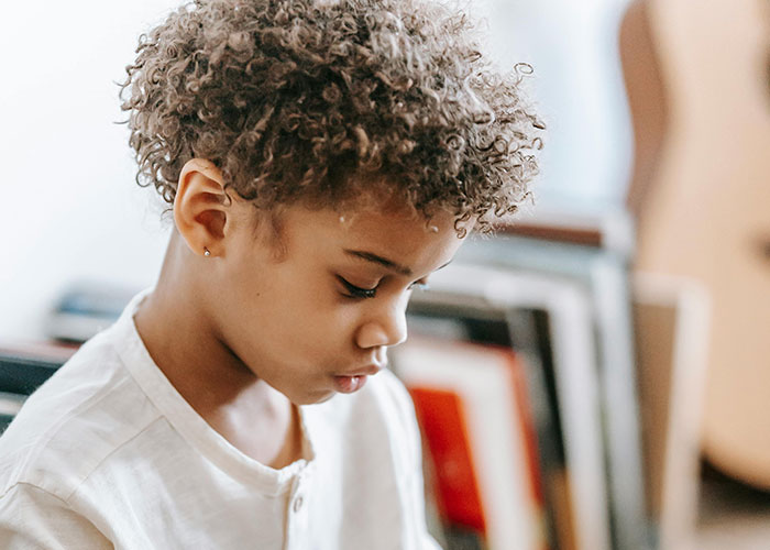 Child focused on activity indoors, representing issues with worst teachers impacting students.
