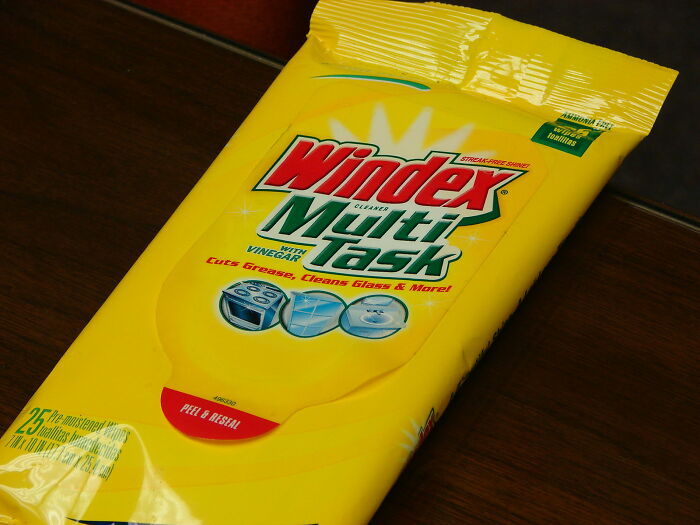 Windex Multi-Task wipes packet on a table, used for cleaning rules people might never budge on.