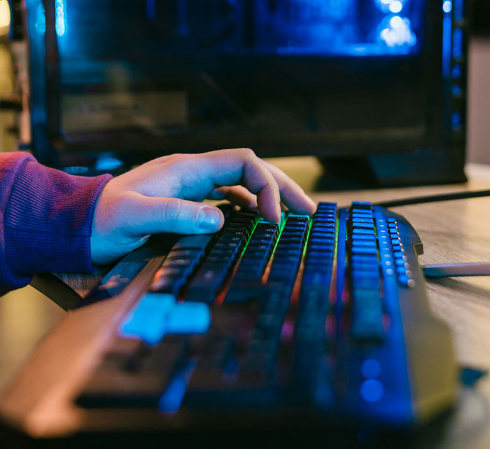 A hand on a colorful keyboard, showcasing internet hacks for easier online navigation.