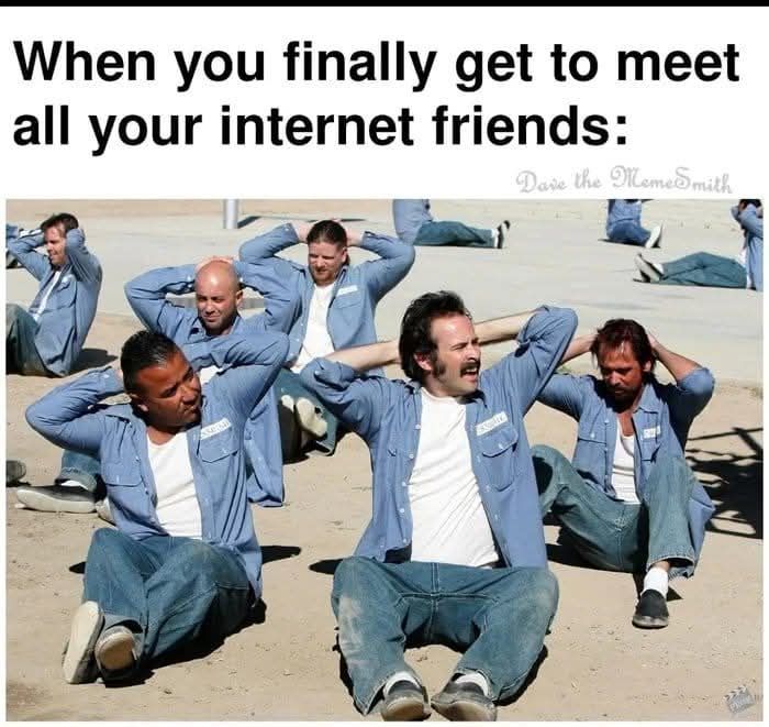 Group of men in blue shirts laughing and sitting on the ground with hands behind heads, a funny meme about internet friends.