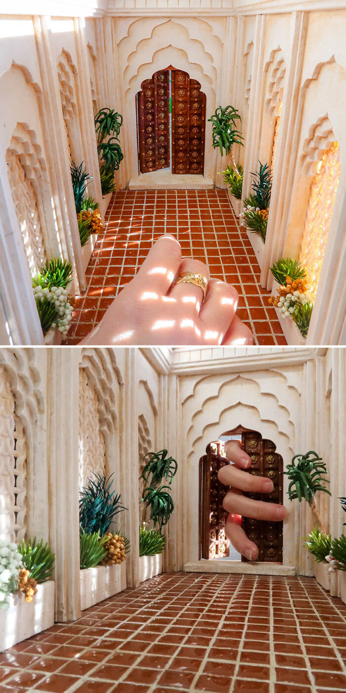 Miniature hallway by Tamar Cohen featuring intricate arches and plants, with a large hand for scale.