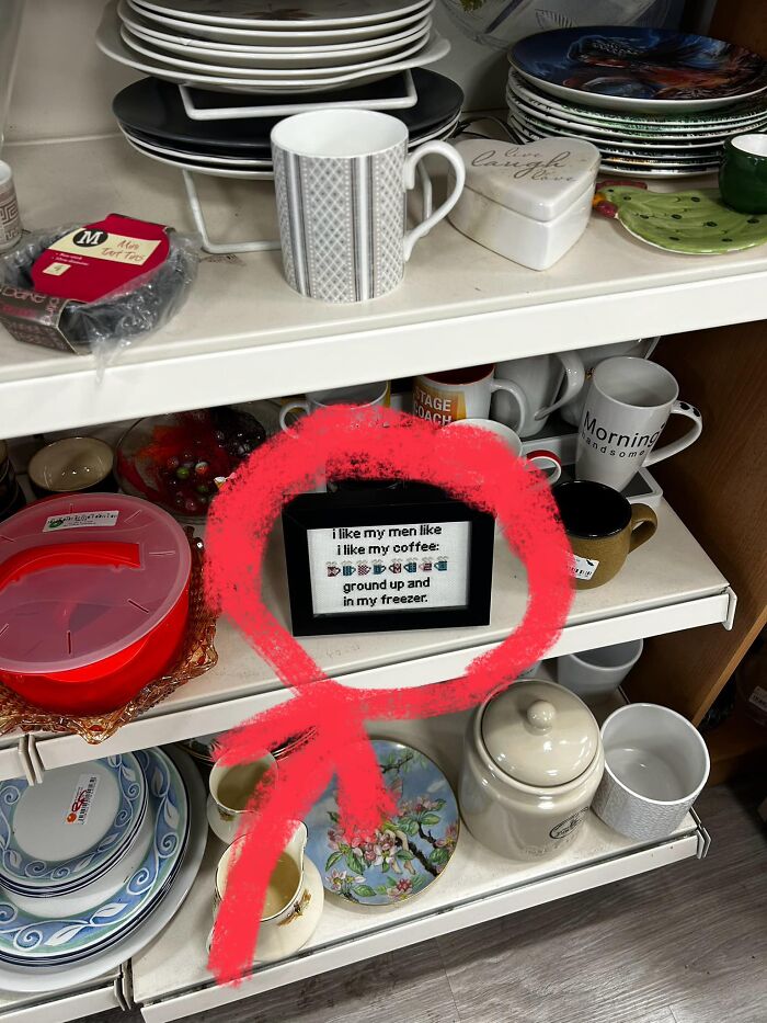 Secondhand shop find: a humorous framed quote about coffee and freezers, surrounded by mugs and plates on shelves.