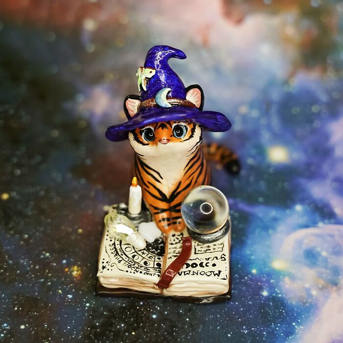 Pocket-sized animal figurine of a cat in a wizard hat with a candle and crystal ball, crafted by Vallavica.