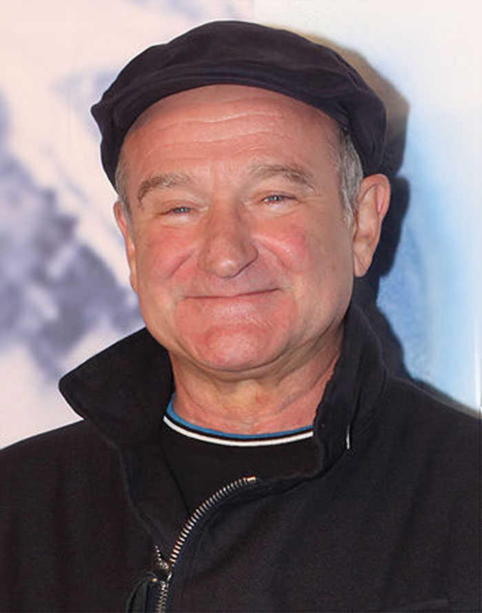 Smiling man in a black cap and jacket, representing beloved stars.