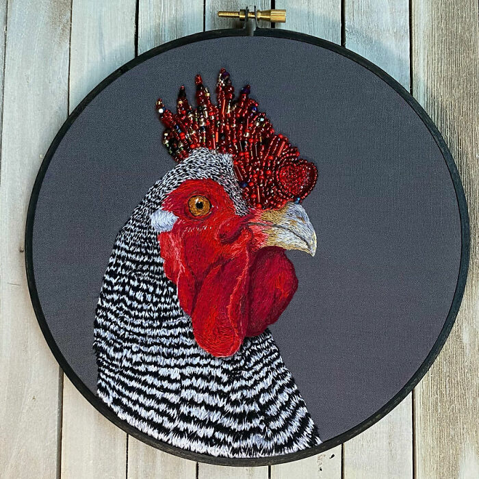 Embroidery work depicting a detailed rooster design with vibrant colors and bead embellishments.