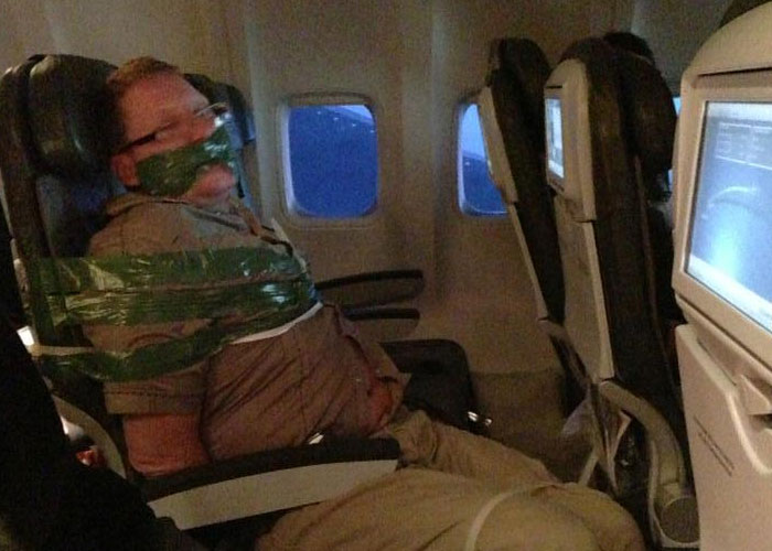 Passenger on plane taped to seat, an unexpected situation mid-flight.
