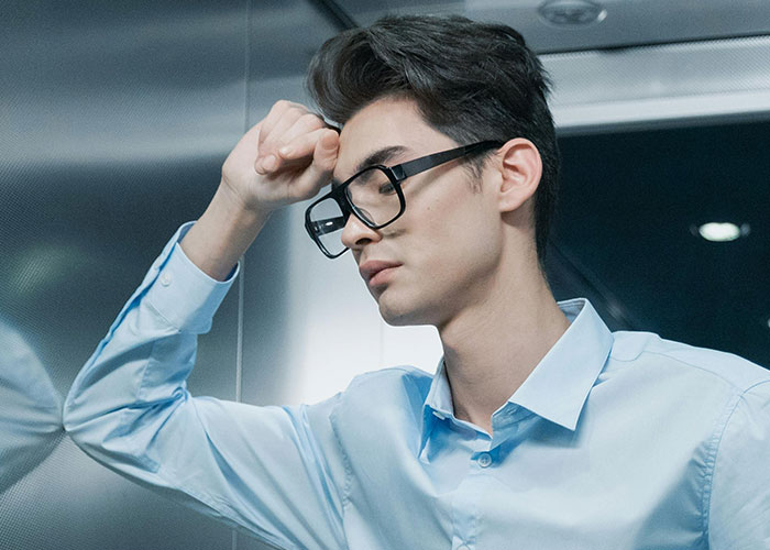 Young man in glasses looking heartbroken and distressed, reflecting on cheating and betrayal in relationships.