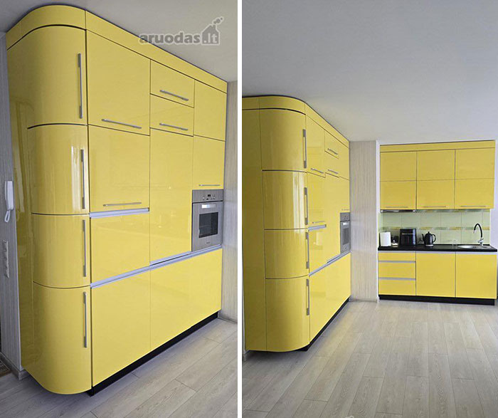 Modern kitchen with glossy yellow cabinets and built-in appliances in a unique real estate property for sale.
