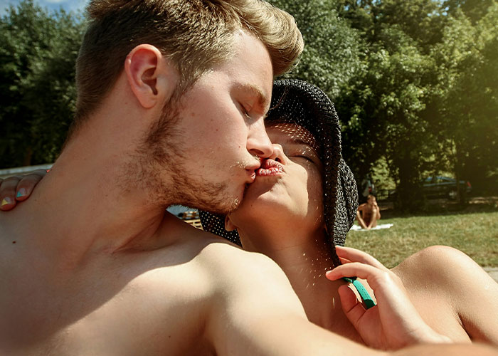 Couple sharing a tender kiss outdoors, illustrating a cheat code for connection discovered in marriage advice.