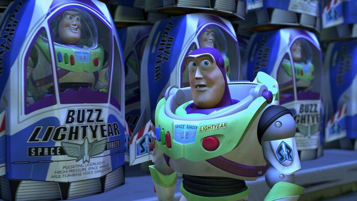 Buzz Lightyear stands in front of toy boxes, reflecting on assumptions about identity and expectations.