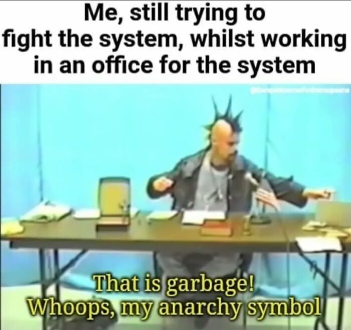 Anarchist with a mohawk in an office-themed meme, humorously highlighting the irony of fighting the system.