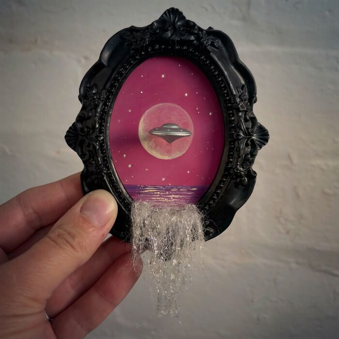 Mini framed diorama with UFO, moon, and mysterious waterfall effect for alien aficionados.