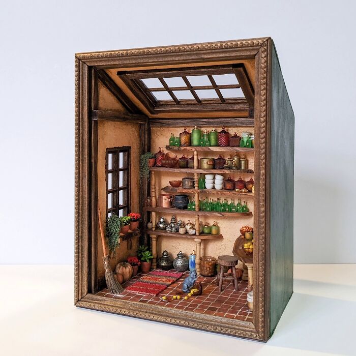 Miniature room by Tamar Cohen featuring shelves with jars, pottery, and decorations, creating a tiny world atmosphere.