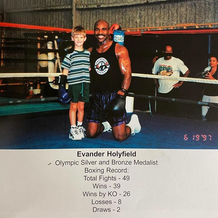 Child posing with a celebrity boxer in a gym setting, highlighting celebrity encounters from a young age, dated 6/19/97.