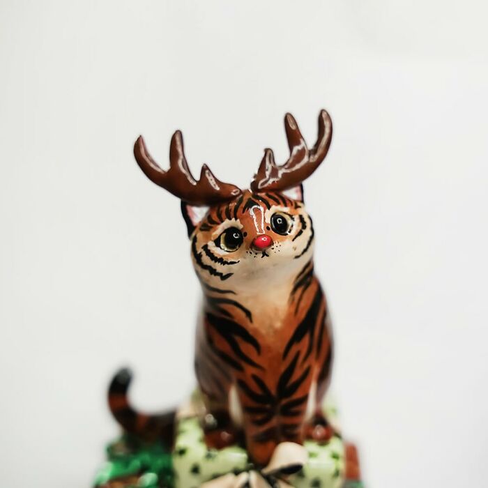 Adorable pocket-sized animal figurine by Vallavica, depicting a whimsical creature with antlers and tiger stripes.