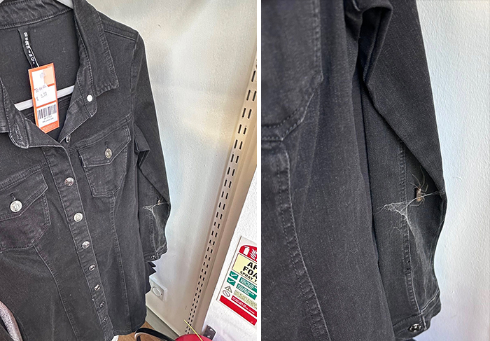 Black denim jacket with visible tear on the sleeve, found at a secondhand shop.