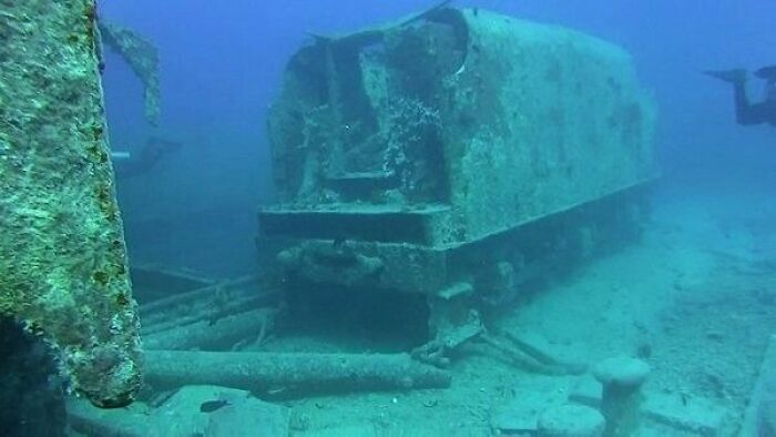 Submerged train car wreck in the ocean, showcasing one of the strangest discoveries underwater.