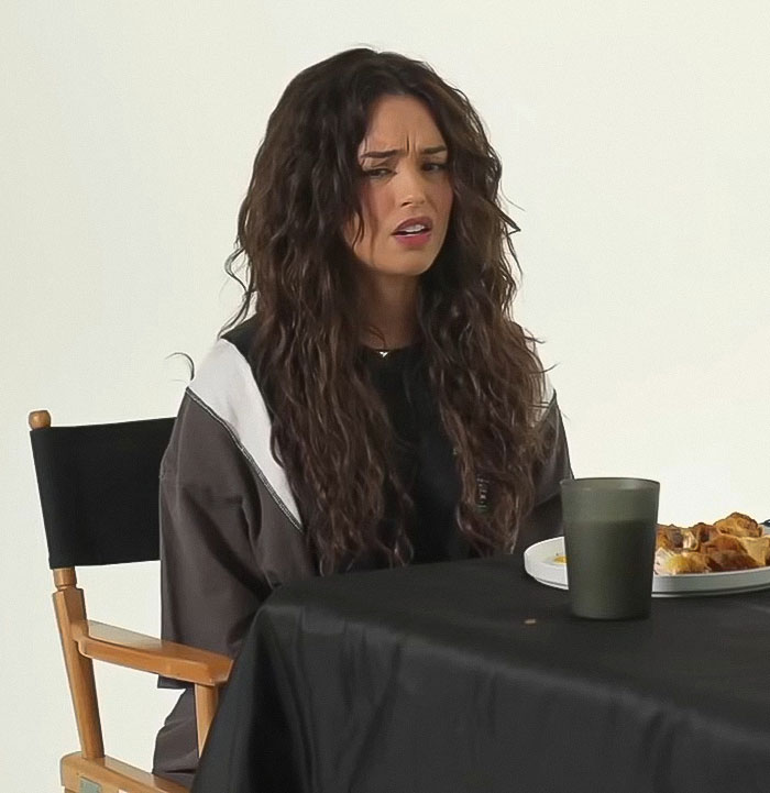 Streamer looking confused while sitting at a table with food, discussing Minecraft scene cut involving Jason Momoa.