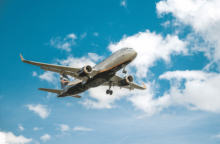 Airplane flying through a cloudy sky, symbolizing distance and connection related to family closeness.