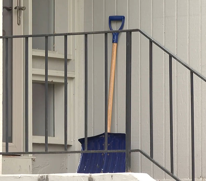 Blue shovel leaning against railing outside a home related to missing teen girl case. Blue shovel leaning against railing outside a home related to missing teen girl case.