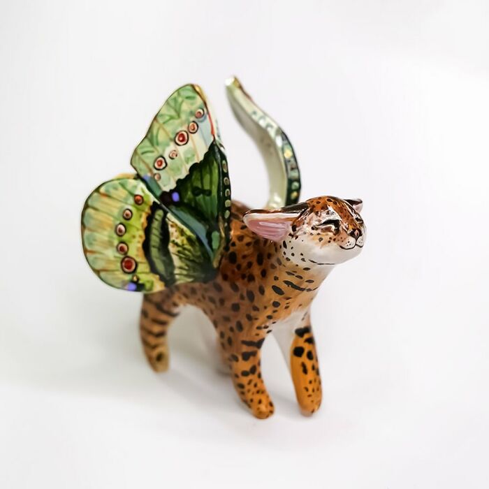 Butterfly-winged animal figurine by Vallavica with spotted fur and closed eyes.