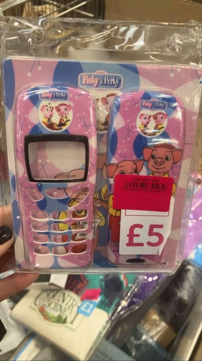 Pink toy phone cover featuring cartoon pigs, priced at £5, found in a secondhand shop treasure hunt.