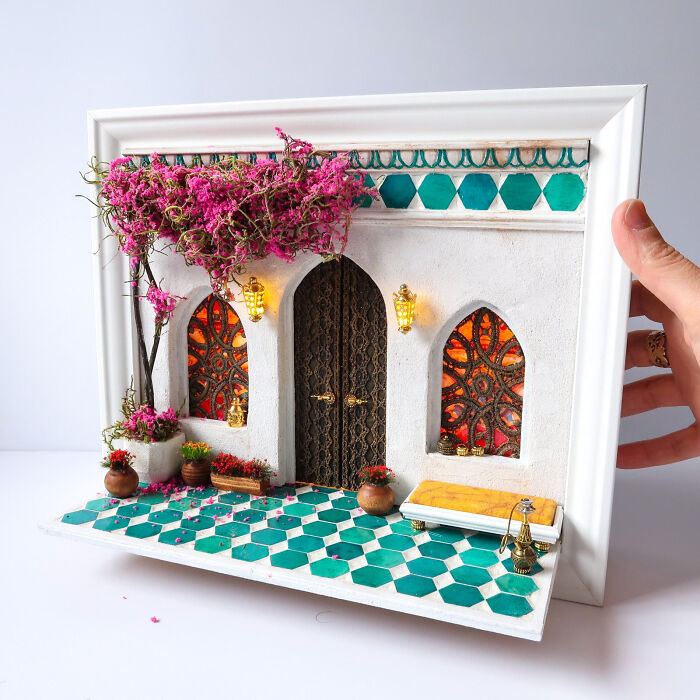 Miniature vibrant scene with ornate windows and a lush tree by Tamar Cohen.
