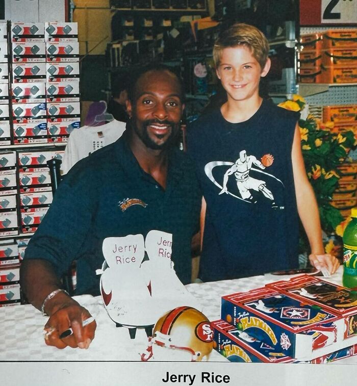 Young fan taking a photo with a celebrity at a signing event.