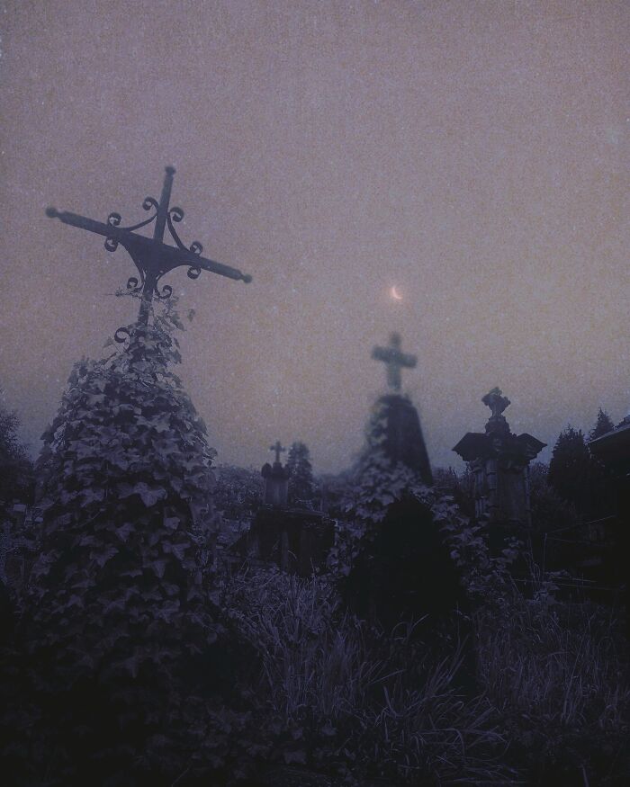 Dreamy dark escapism photography featuring moonlit crosses and ivy-covered graves in a misty, ethereal setting.