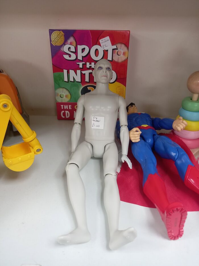 Unusual secondhand find: mannequin doll sits beside a Superman figure.