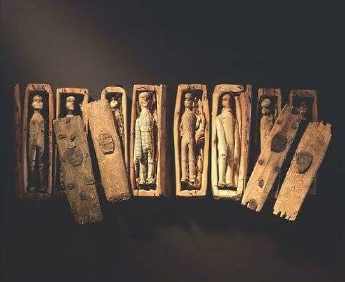Ancient wooden artifact: miniature figures in tiny coffins, providing a brief history lesson in an intriguing way.