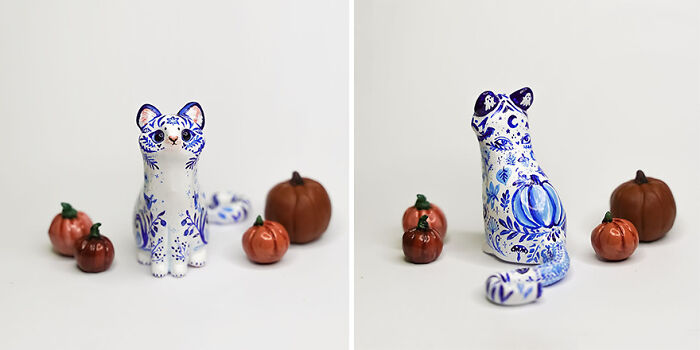 Pocket-sized animal figurine by Vallavica, featuring a blue-and-white patterned cat with small pumpkins.