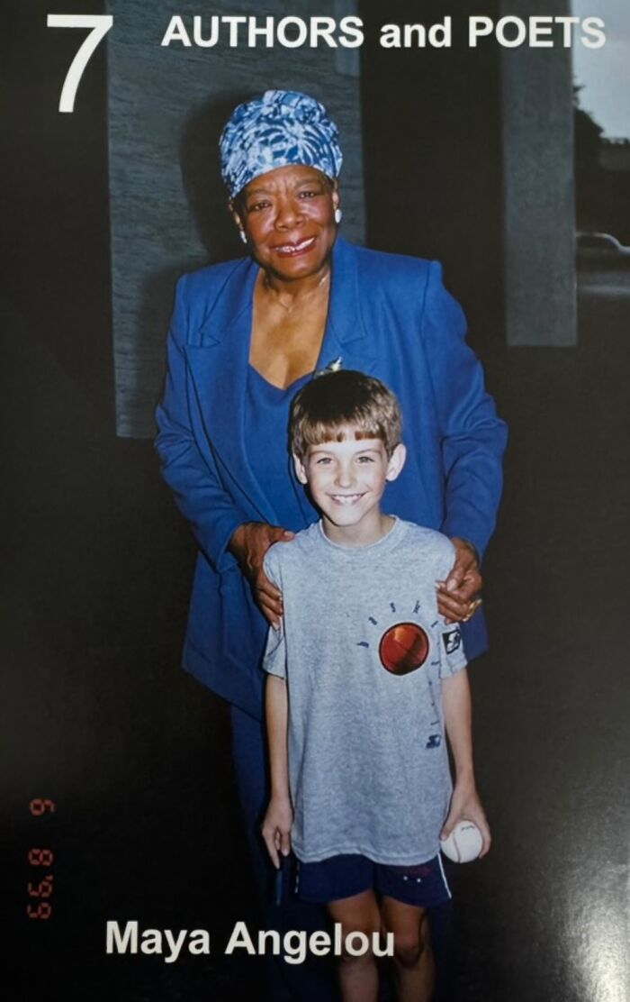 Young boy photographed with a celebrity author, both smiling warmly, capturing a cherished moment.