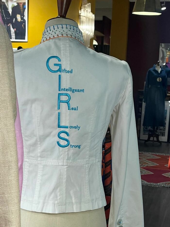 White shirt with "GIRLS" acronym: Gifted, Intelligeant, Real, Lovely, Strong. Confidently incorrect spelling displayed.