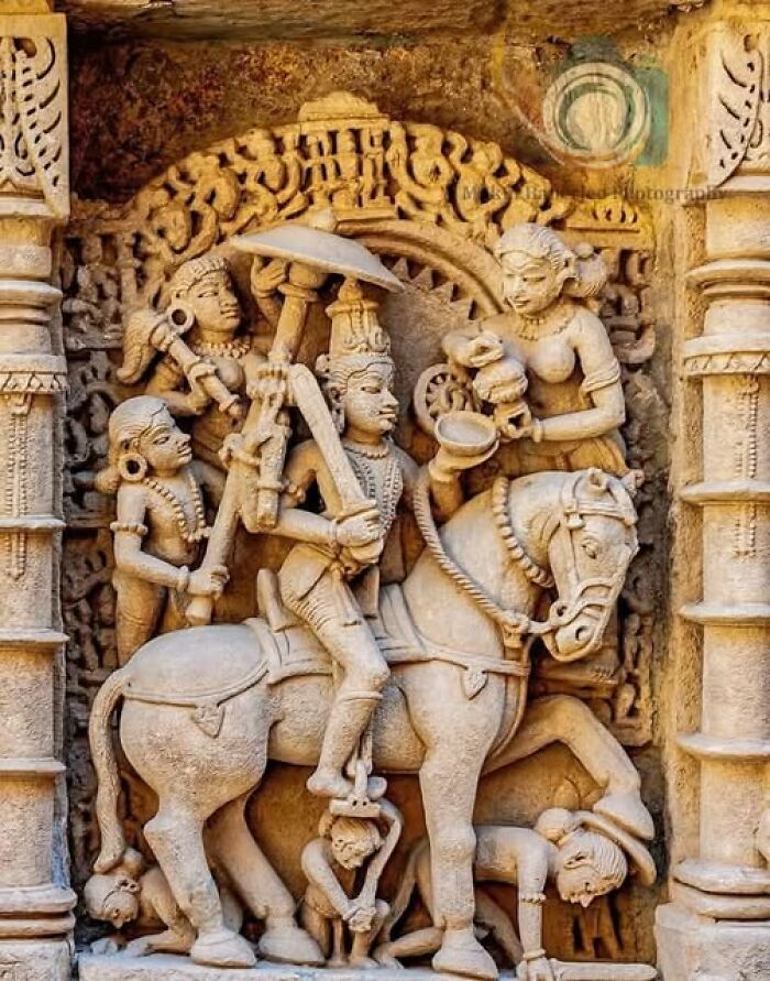 Intricately carved ancient stone sculpture depicting a royal figure on horseback surrounded by attendants in archaeology news.