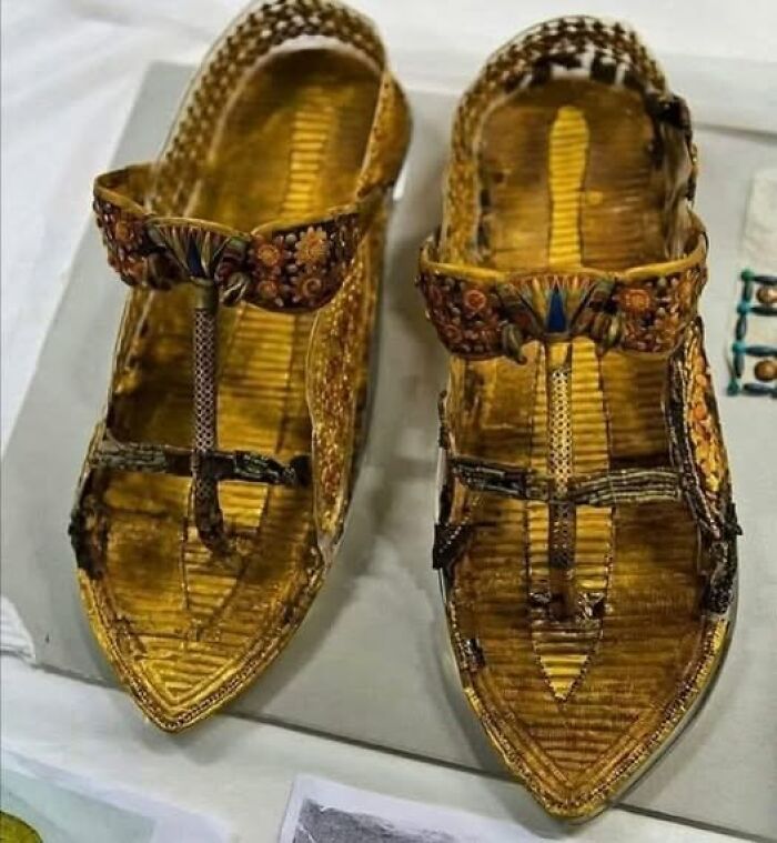 Ancient golden sandals with detailed floral and geometric designs, featured in archaeology news and architecture exhibits.
