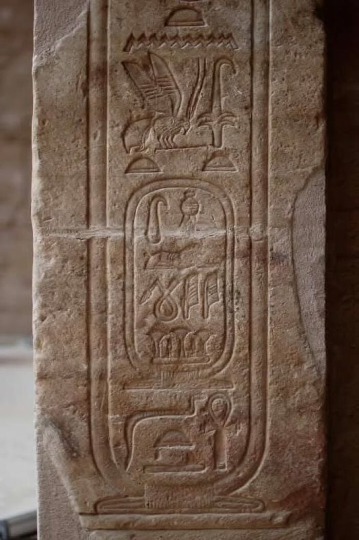 Ancient Egyptian hieroglyphs carved in stone, showcasing archaeology details from historical architecture sites.