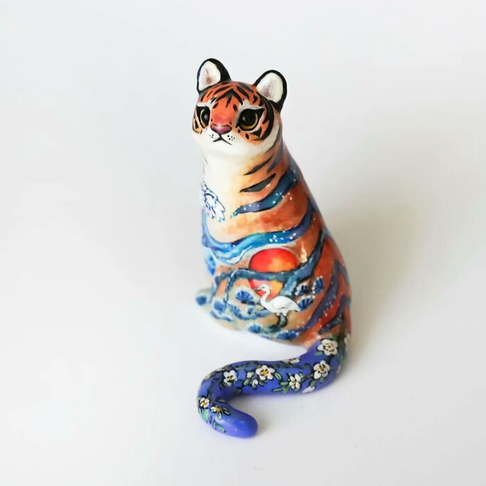 Colorful pocket-sized animal figurine by Vallavica, featuring a detailed tiger design with vibrant patterns.