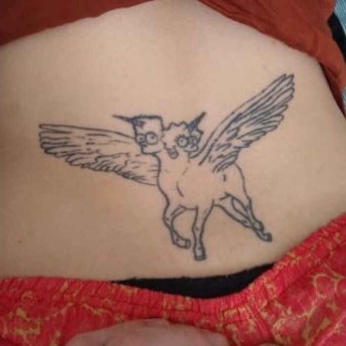 Simpsons tattoo of a two-headed winged creature with glasses, wearing an orange garment.