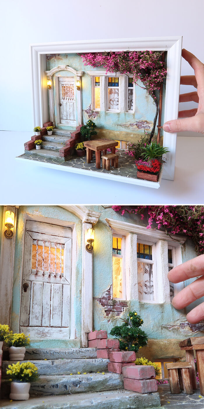 Miniature scene by Tamar Cohen featuring a quaint house exterior with floral details and a hand for scale.