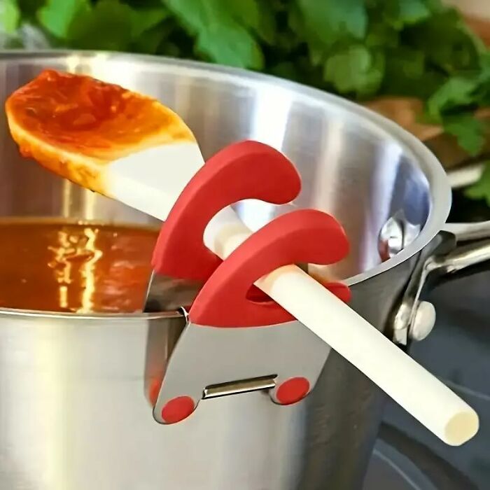 Silicone spoon rest clip holding a spatula on a pot, a popular Amazon haul for kitchen deals on cooking tools.