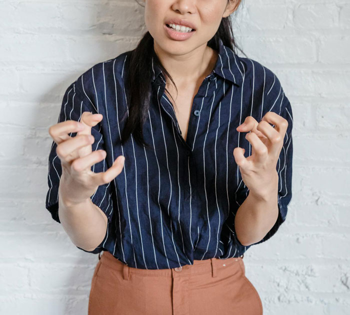 A woman in a striped shirt expressing frustration after a prank, embodying relationship tension.